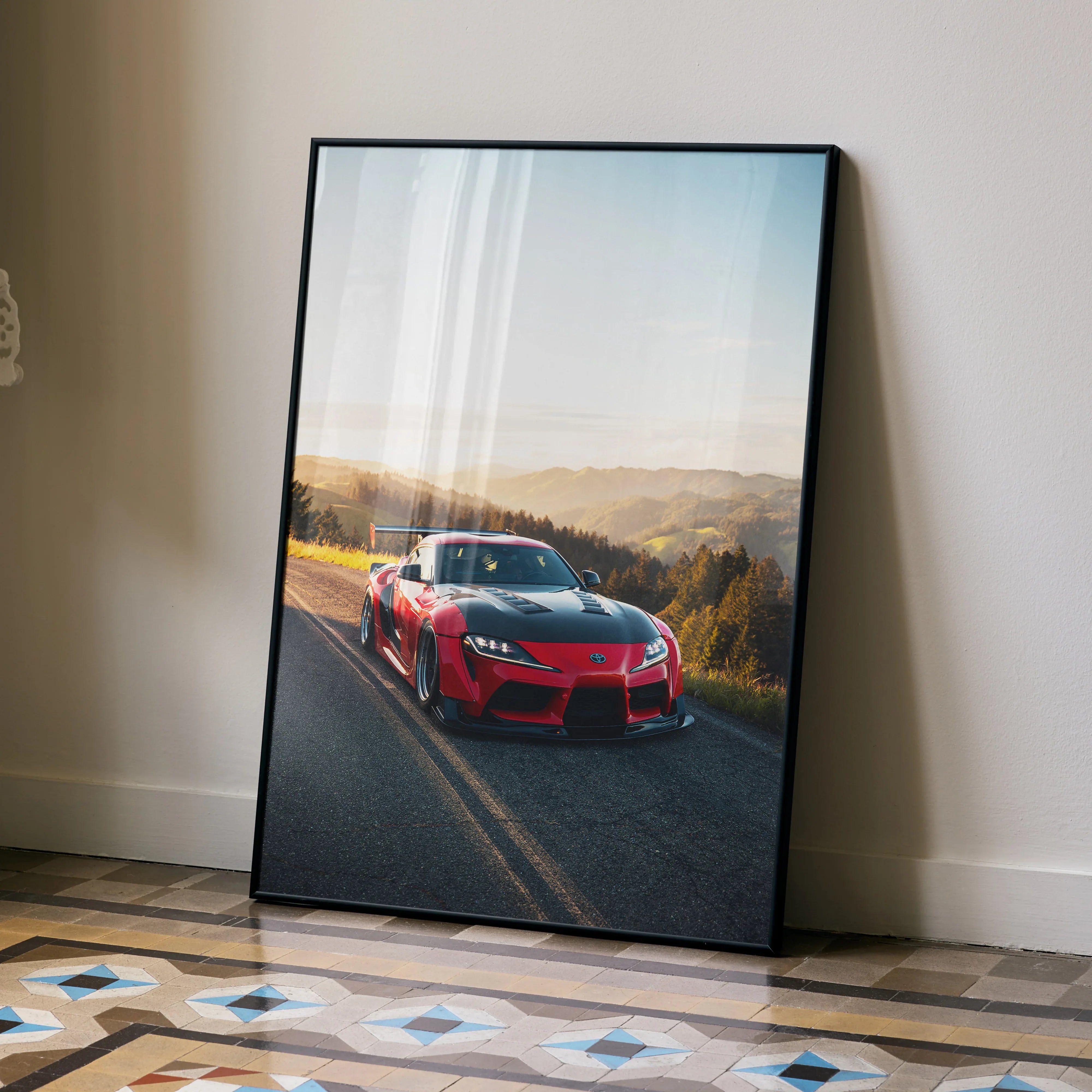 Toyota Supra Mk5 driving on scenic road at sunset poster wall art in premium satin finish.