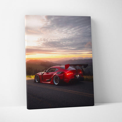 Vertical canvas wall art of red Toyota Supra MK5 at sunset with dramatic sky and landscape.