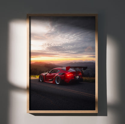 Toyota Supra Mk5 in red parked on roadside at sunset poster wall art with dramatic sky.