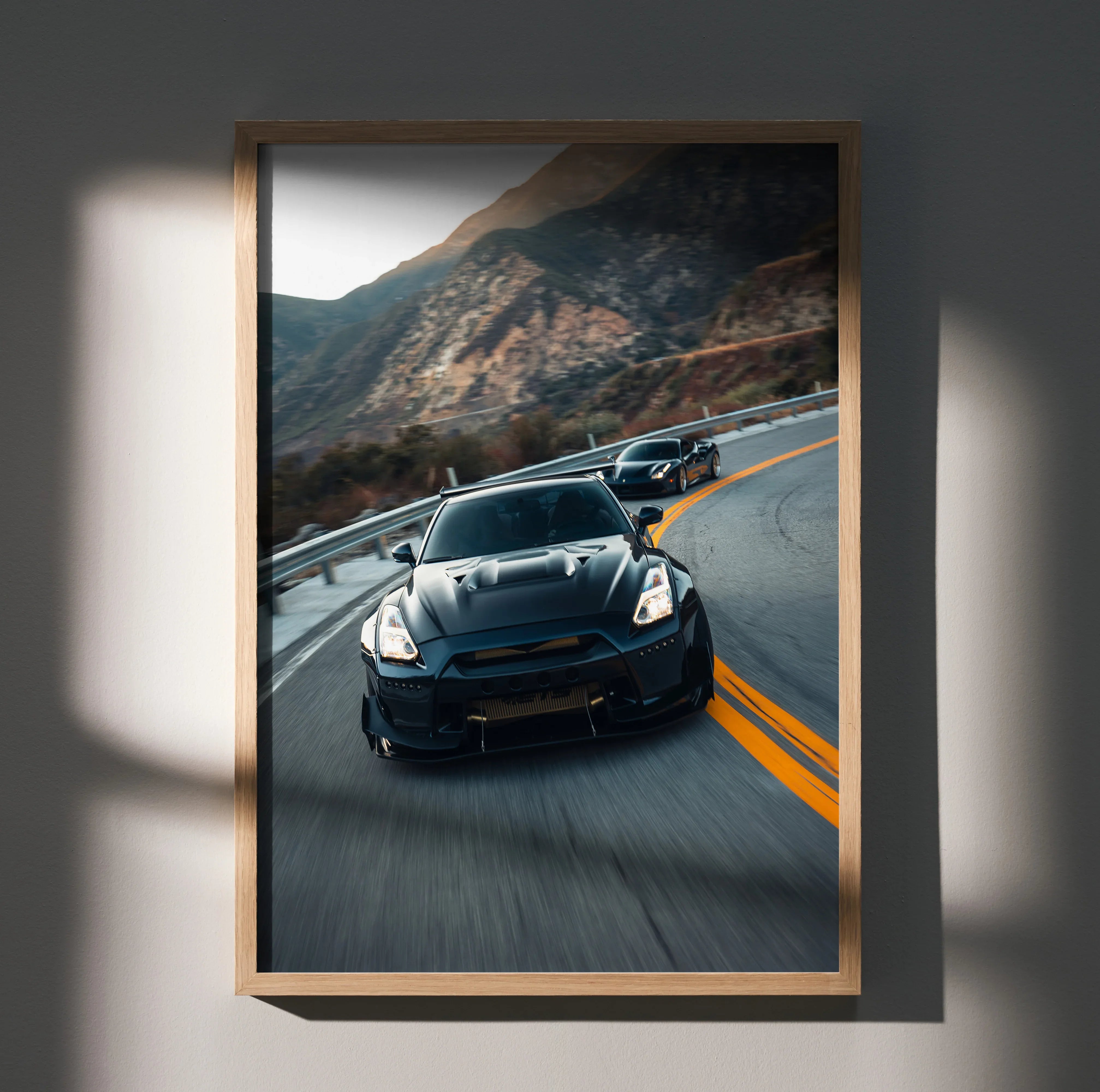 Nissan GTR R35 widebody speeding on mountain road poster wall art in wooden frame.