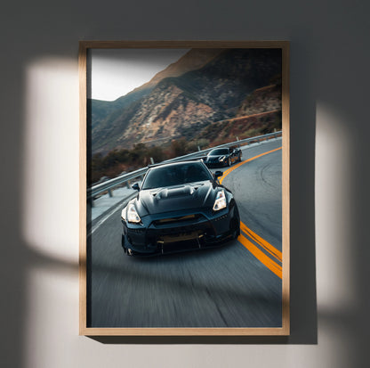 Nissan GTR R35 widebody speeding on mountain road poster wall art in wooden frame.