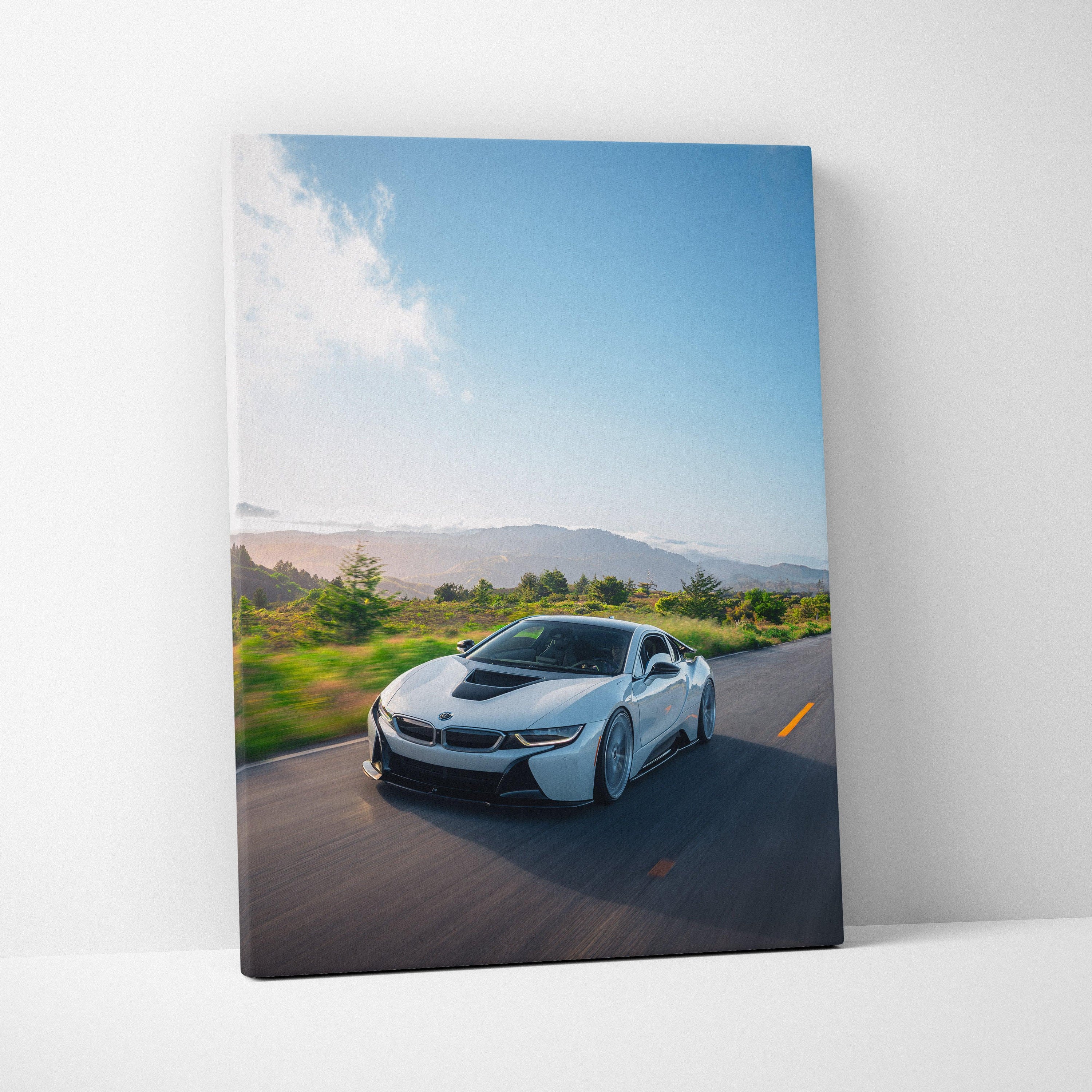 BMW i8 driving on open road with blue sky canvas wall art vertical print.