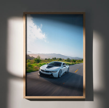 BMW i8 car poster in motion on open road with blue sky wall art in wooden frame.