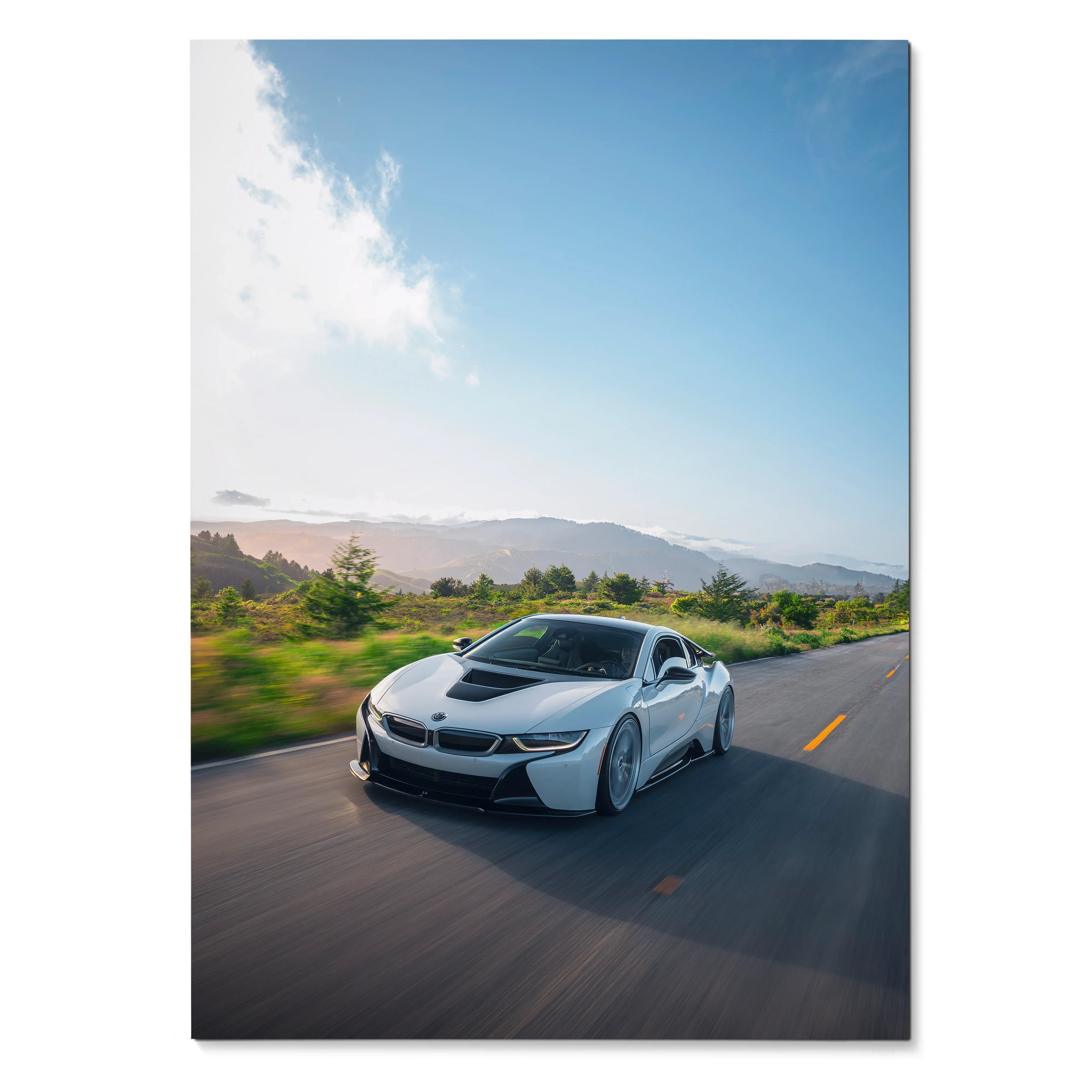 BMW i8 sports car driving on open road with blue sky poster wall art.