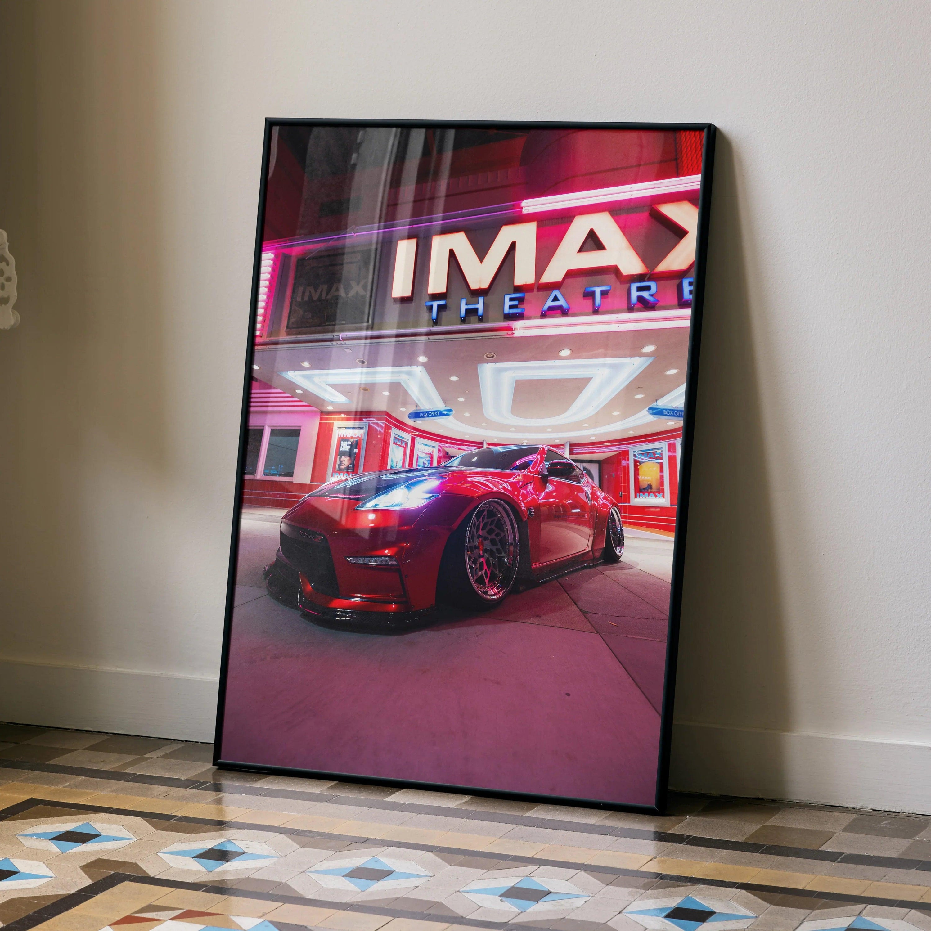 Nissan 370z poster with vibrant red car and illuminated IMAX theater wall art in black frame.