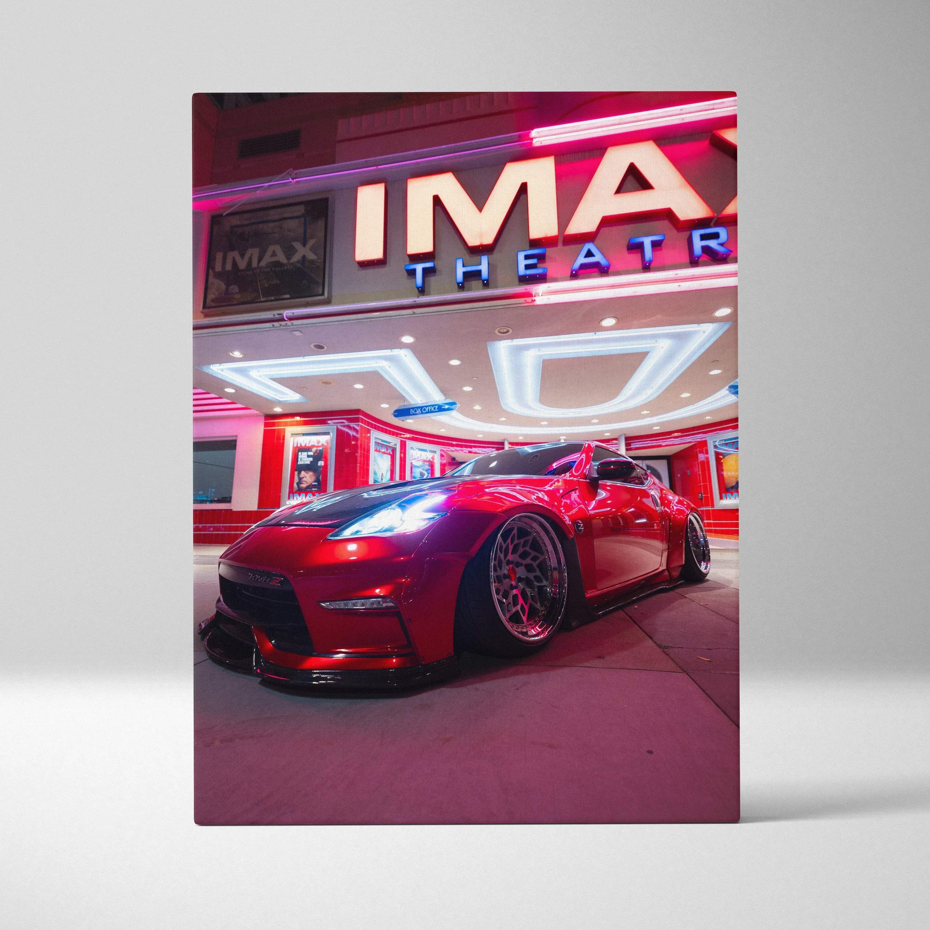 Nissan 370z sports car parked under neon-lit IMAX theater sign canvas wall art.