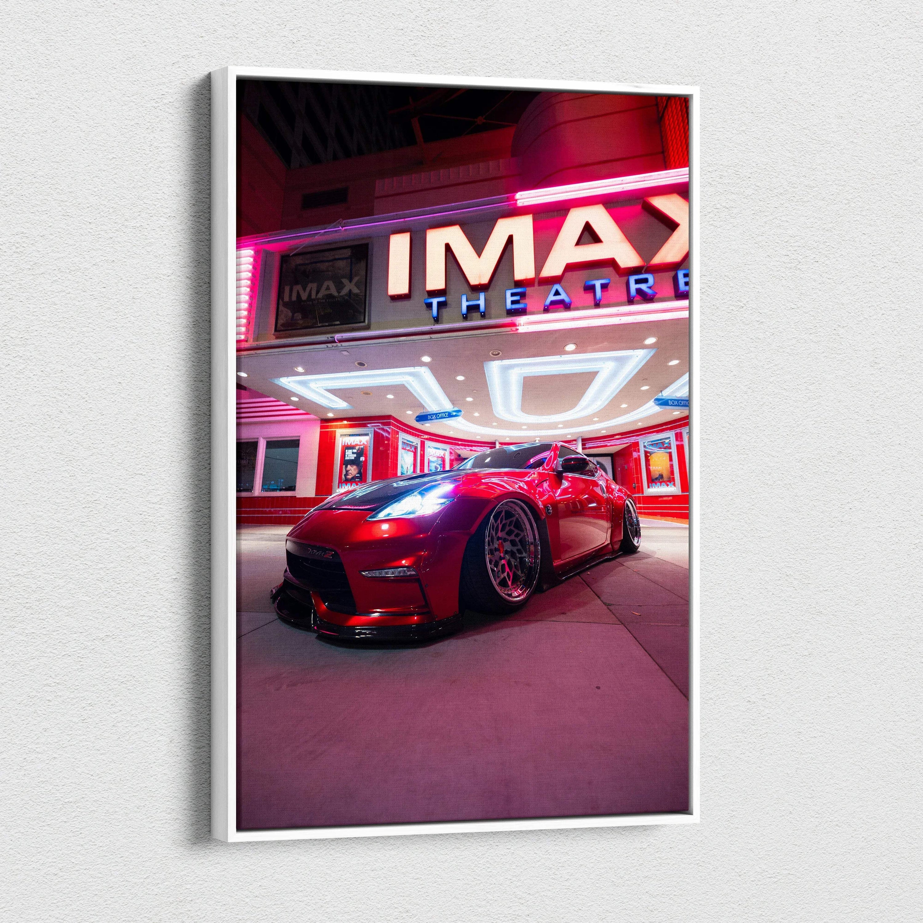 Vertical canvas art featuring a red Nissan 370z parked under vibrant neon IMAX theater lights, modern wall art.