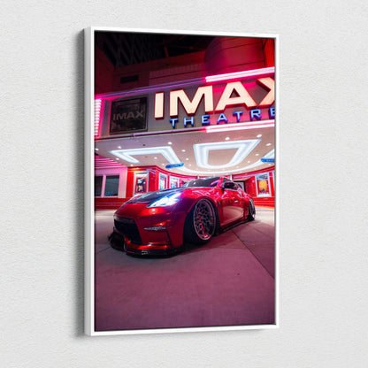 Vertical canvas art featuring a red Nissan 370z parked under vibrant neon IMAX theater lights, modern wall art.