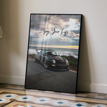Motivational poster wall art featuring black RWB Porsche 911 with "Enjoy Your Life" text against cloudy sky background.