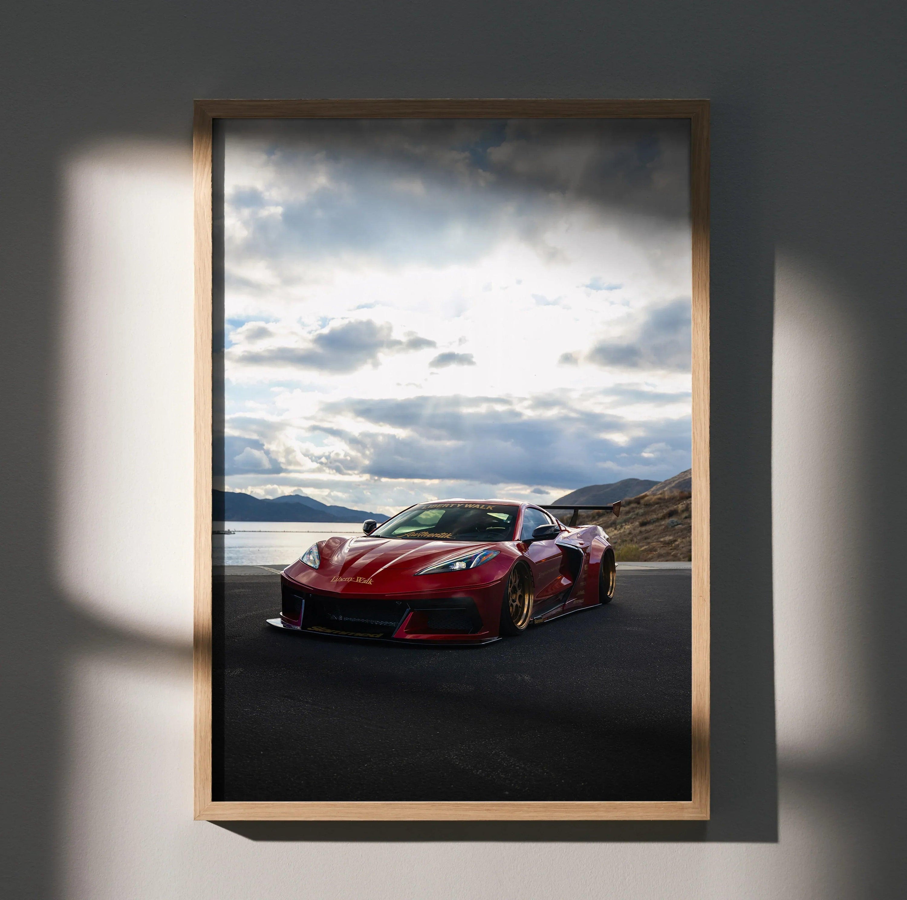 Red C8 Corvette sports car on asphalt with cloudy sky, displayed as premium satin wall art poster in wooden frame.