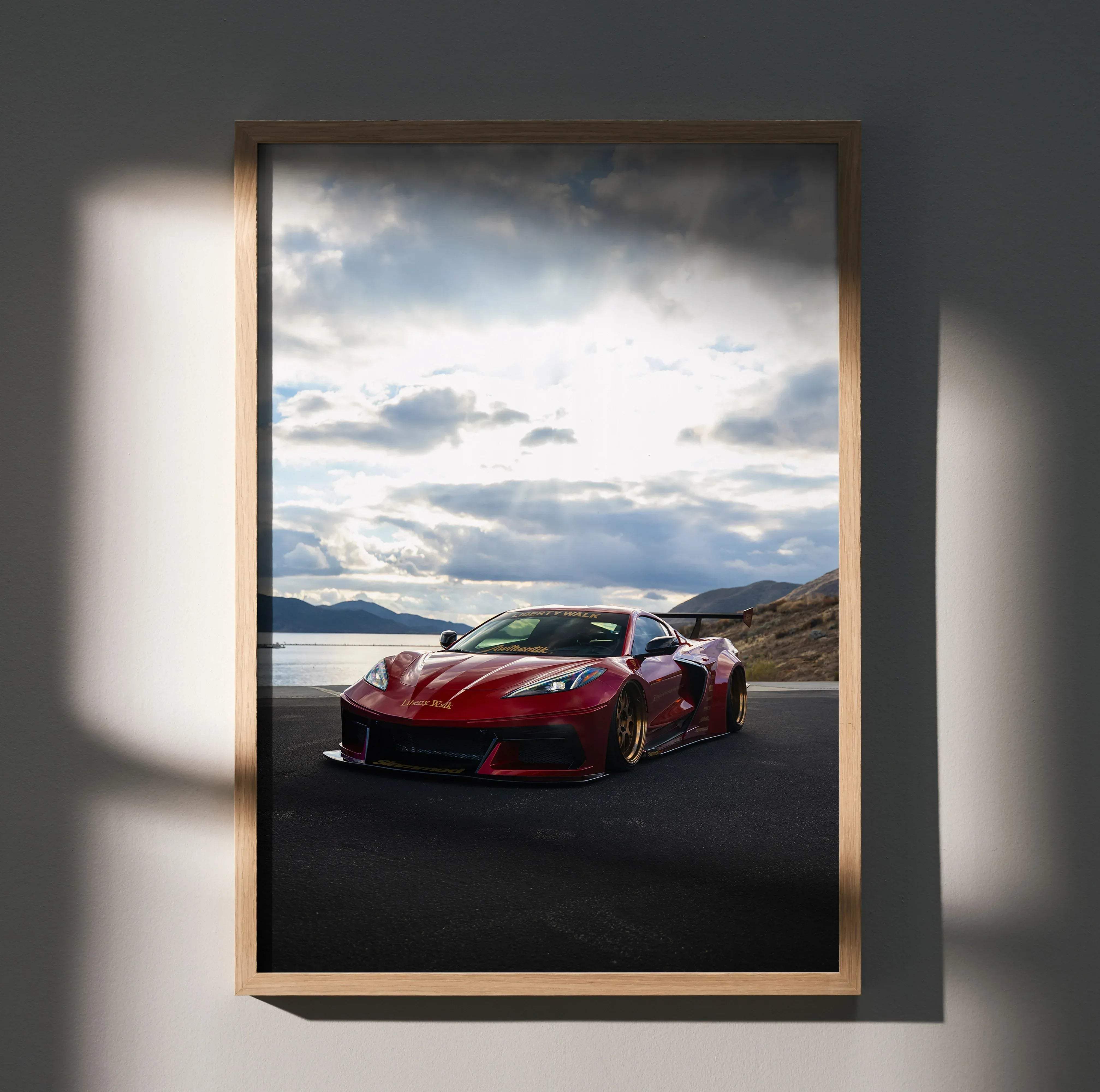 Red chevrolet corvette c8 sports car poster in a light wood frame high resolution satin wall art for enthusiasts