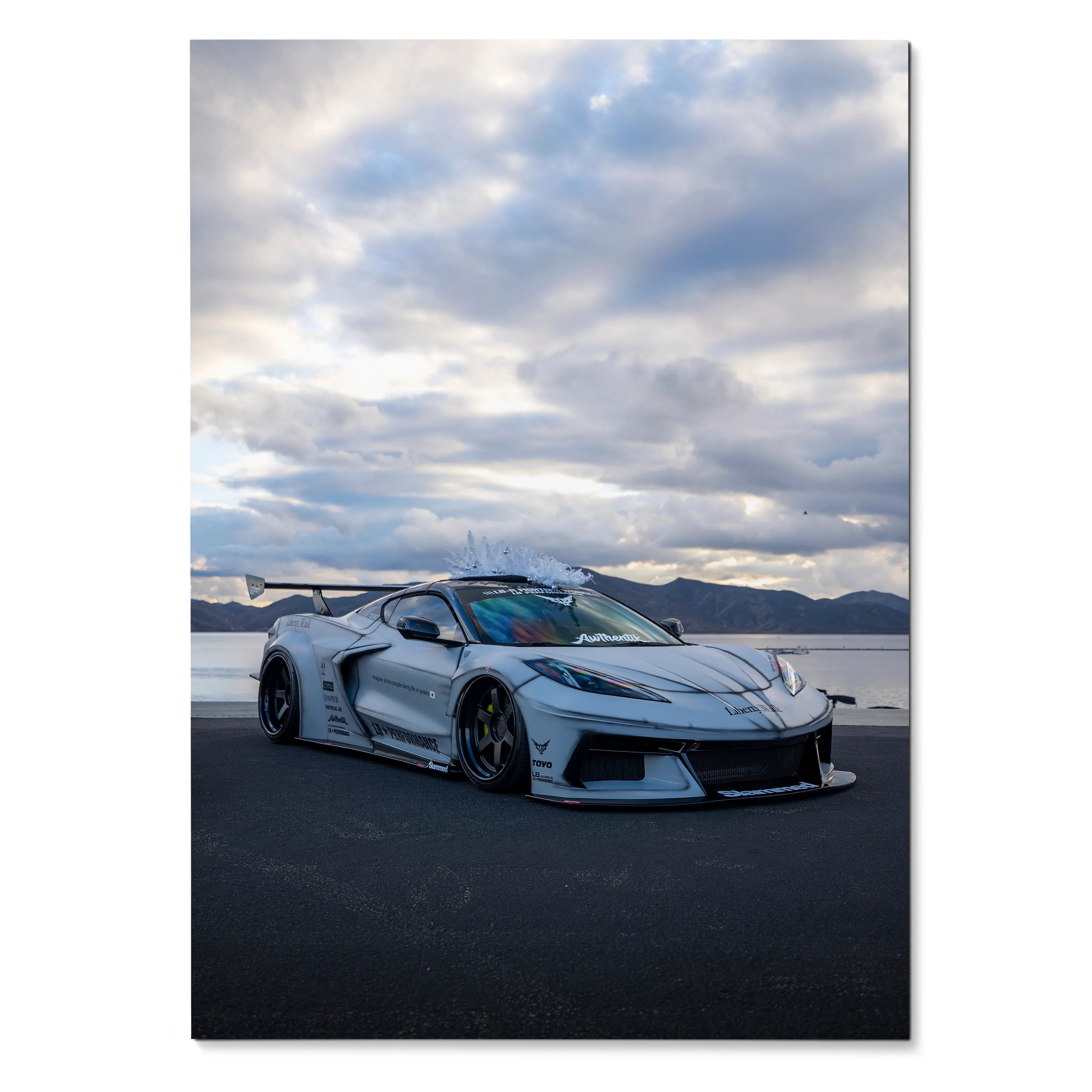 Chevrolet C8 Corvette sports car in white parked on asphalt with dramatic cloudy sky poster wall art.