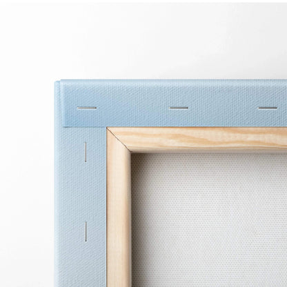 Close-up of light blue stretched canvas and wooden frame corner for vertical wall art canvas print.