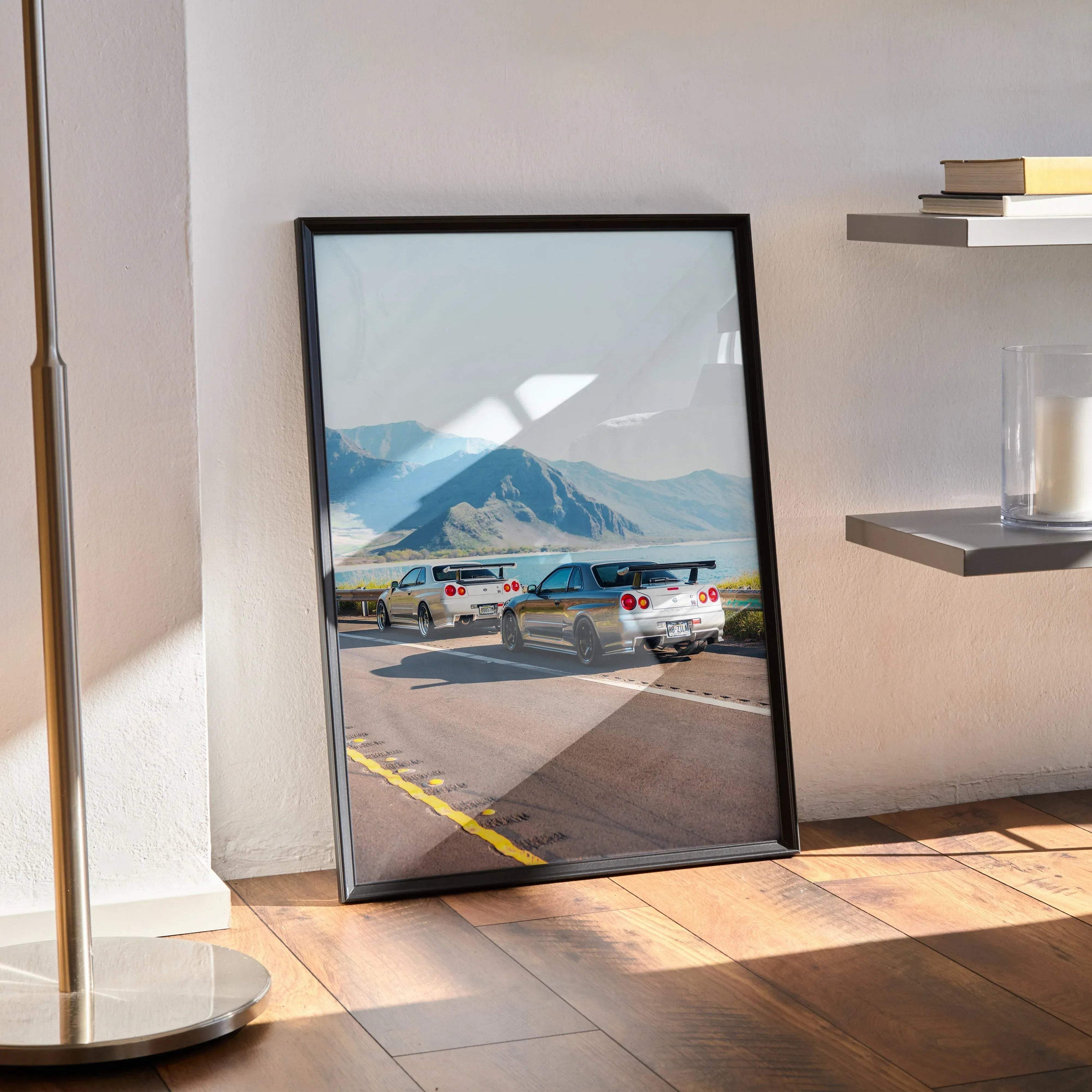 Nissan GT-R R34 Skyline poster with cars on runway and mountain background wall art.