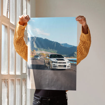 Nissan GT-R R34 Skyline poster featuring white sports car on mountainous road, wall art for car enthusiasts.