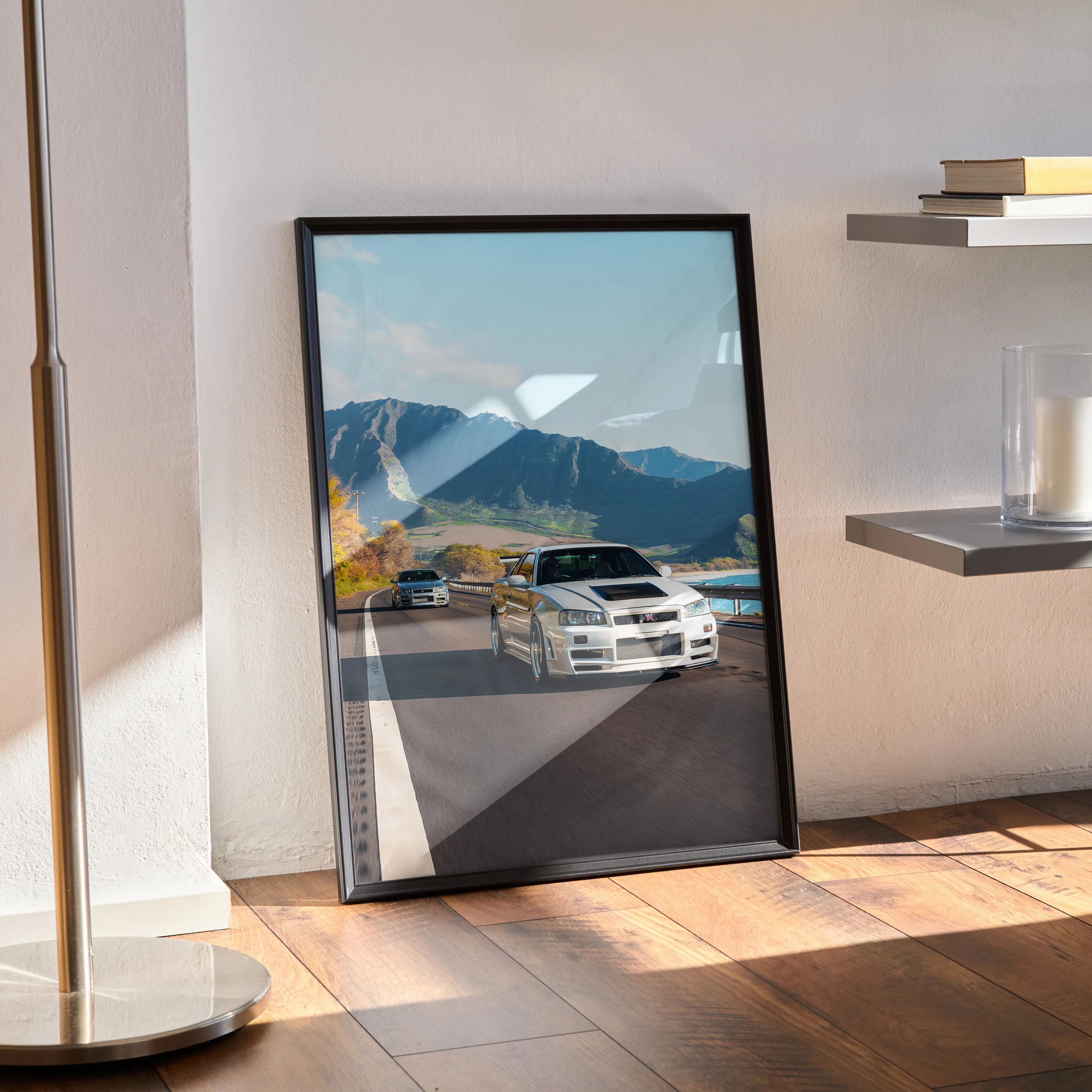 Nissan GT-R R34 Skyline poster with mountain background, sleek sports car wall art in black frame.