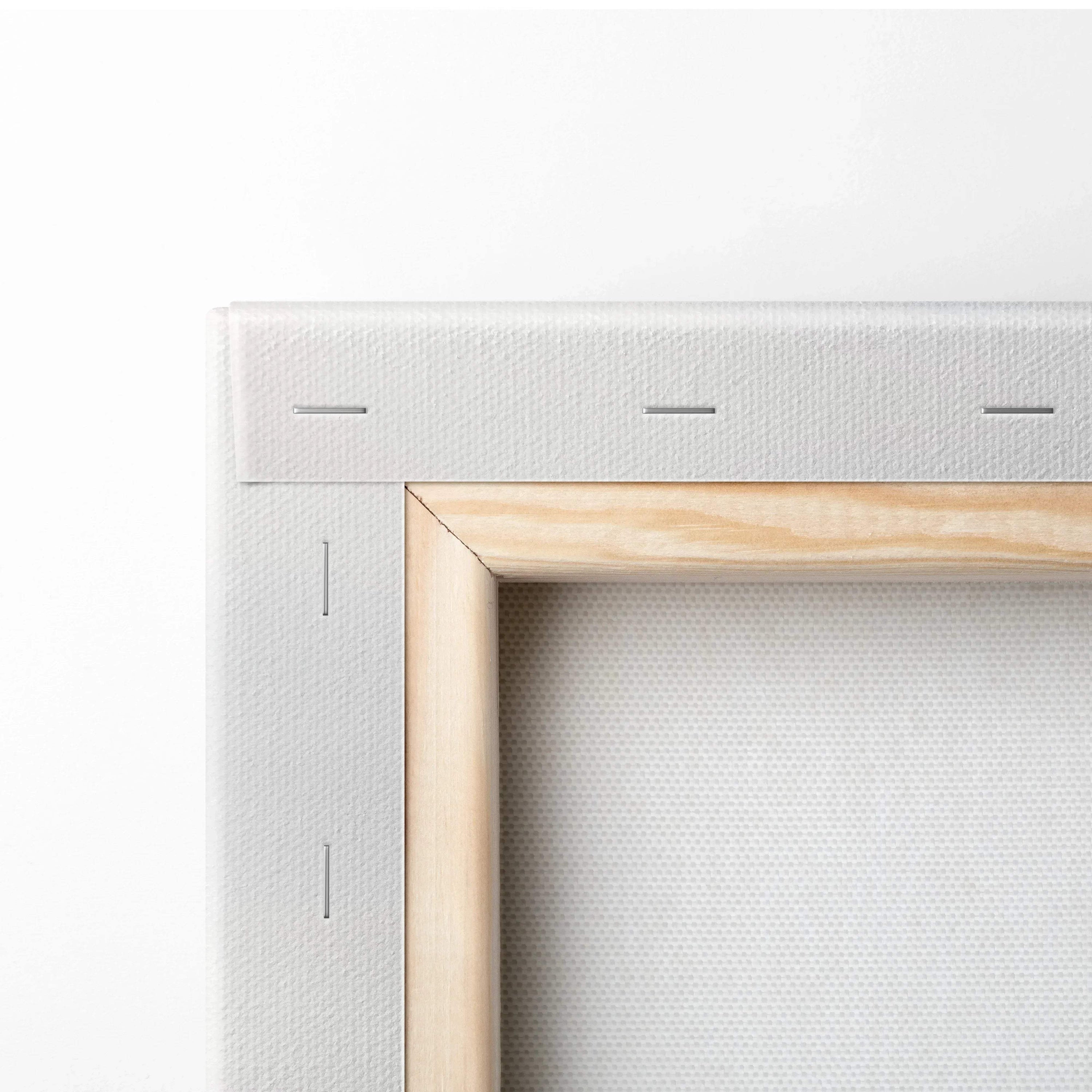 Close-up of stretched white canvas on wooden frame showing tight stapled edges for wall art canvas print.