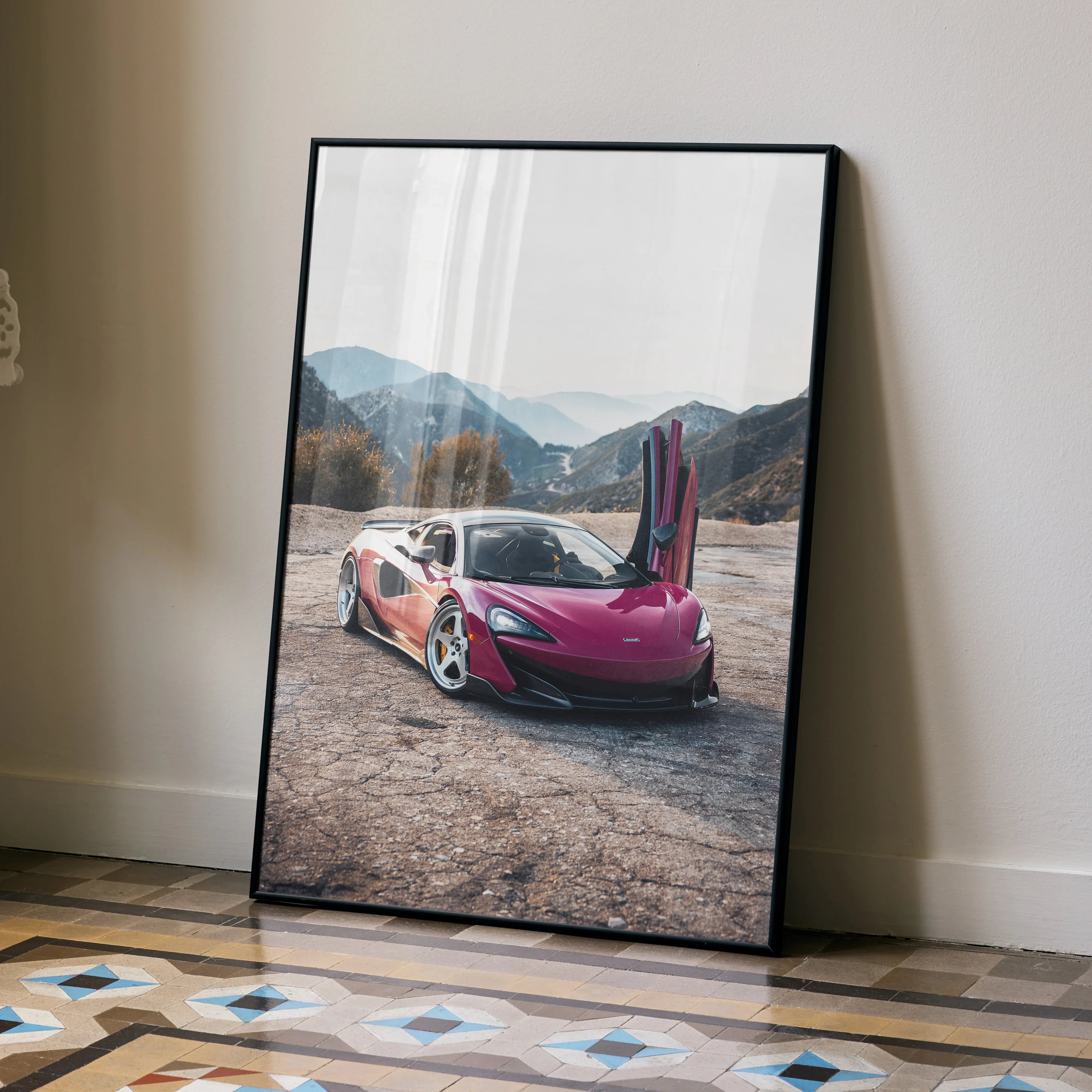 McLaren 600LT poster with butterfly doors open in mountain landscape, wall art in black frame.