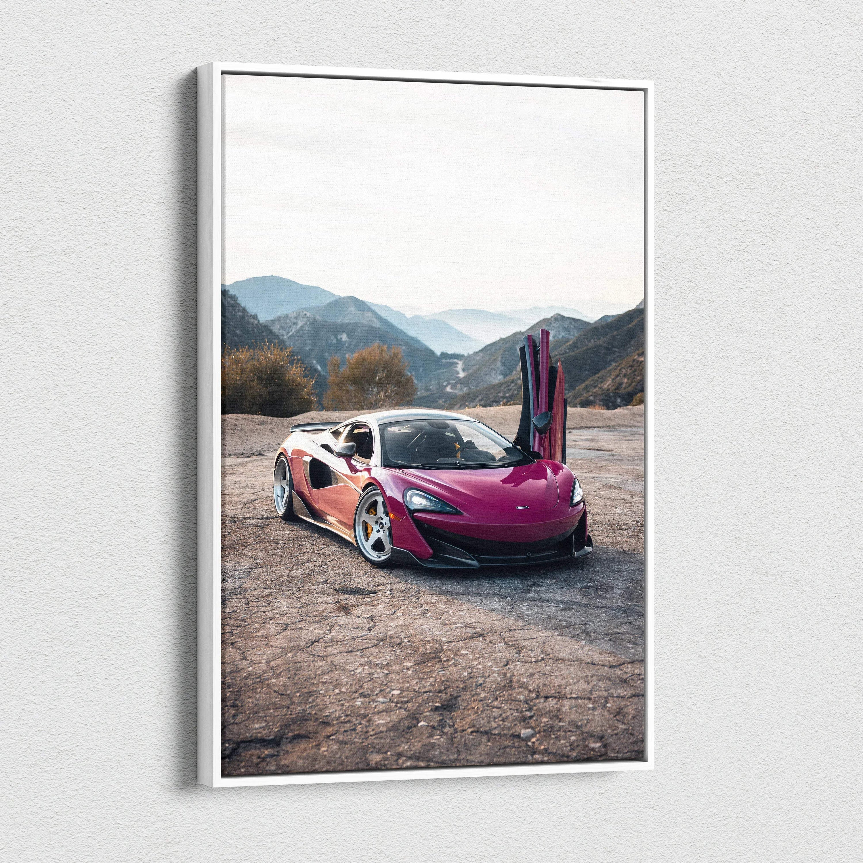 Vertical canvas wall art of a pink McLaren 600LT with open door on a mountain road, high-resolution canvas art.