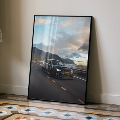 Subaru WRX STI driving on coastal road under cloudy sky poster wall art in black frame.