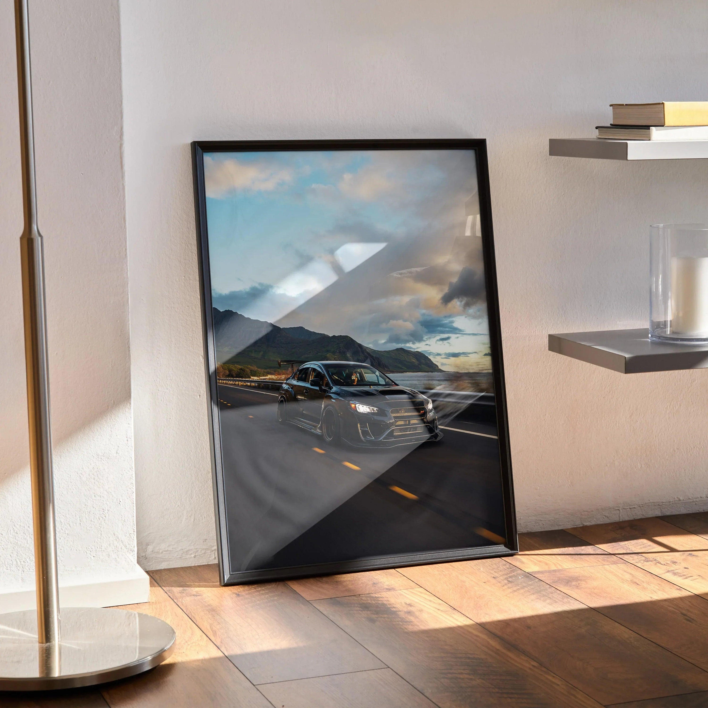 Subaru WRX STI driving on scenic highway poster wall art with dramatic sky in black frame.