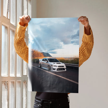 Slammed white Subaru WRX on road under cloudy sky poster wall art.