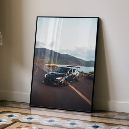 Subaru WRX STI black sports car on coastal road poster wall art with mountain background.
