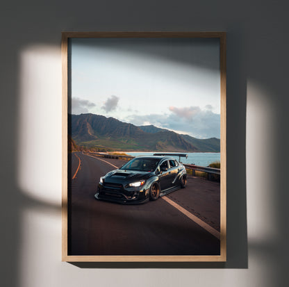 Subaru WRX STI car on coastal road at sunset poster, high-resolution wall art in natural wood frame.