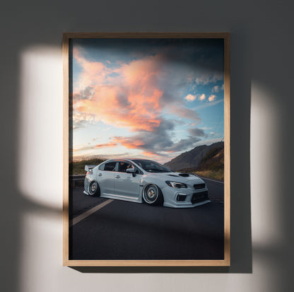 Subaru WRX parked on road with vibrant sunset sky poster wall art.