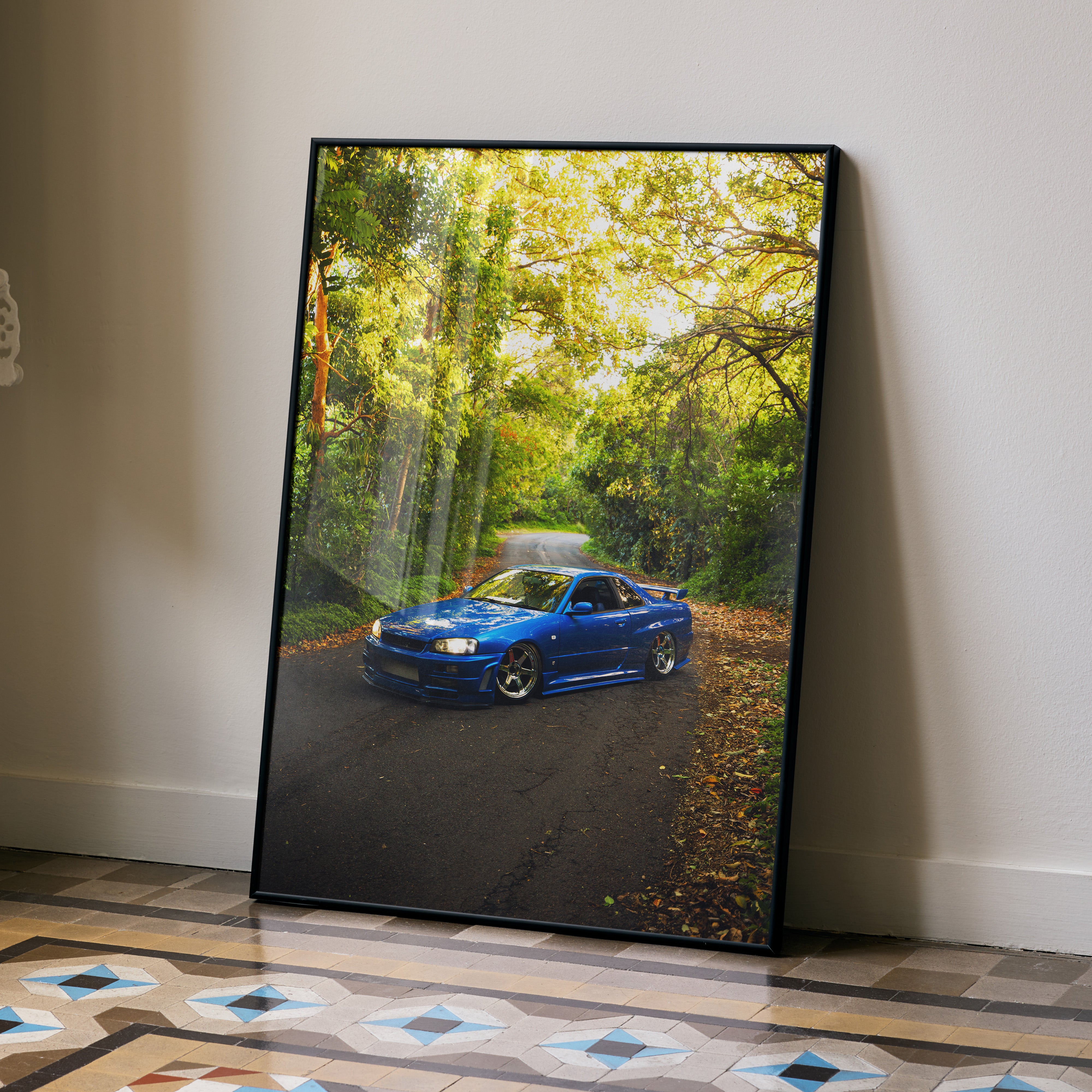 Nissan Skyline GTR R34 blue car poster with forest road wall art in black frame.