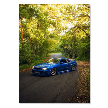 Nissan Skyline R34 GTR blue car on forest road poster wall art in vibrant green setting.