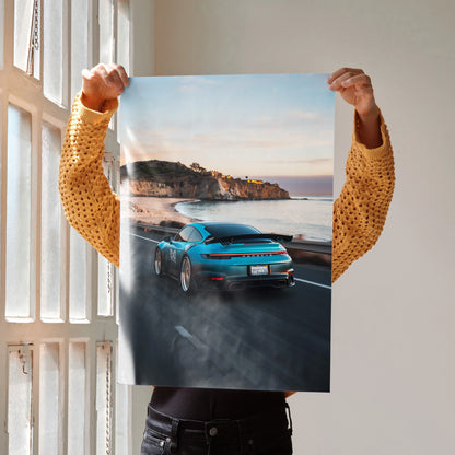 Porsche 911 sports car driving on coastal road at sunset poster wall art.