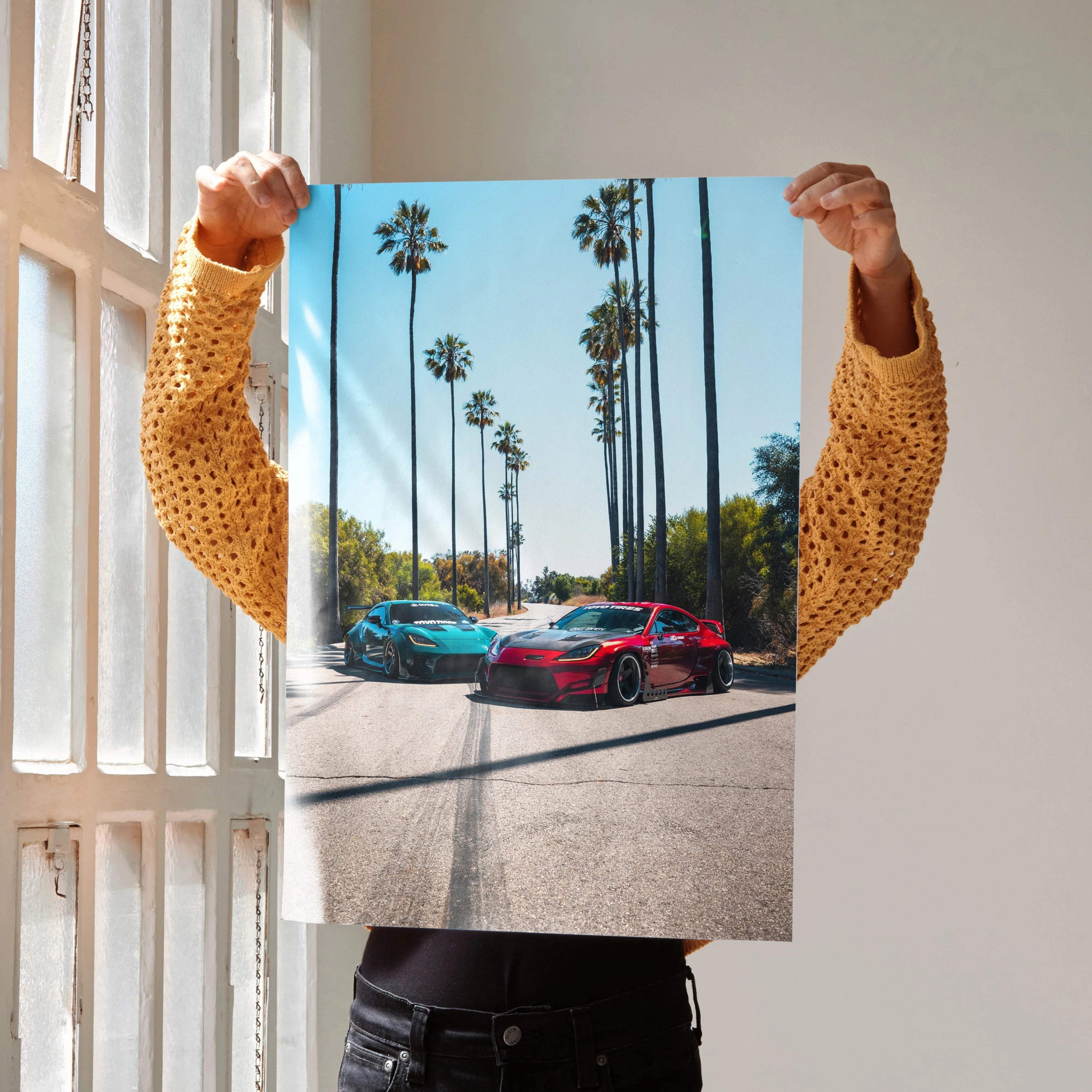 Toyota GR86 red sports car poster with palm trees and clear blue sky wall art.