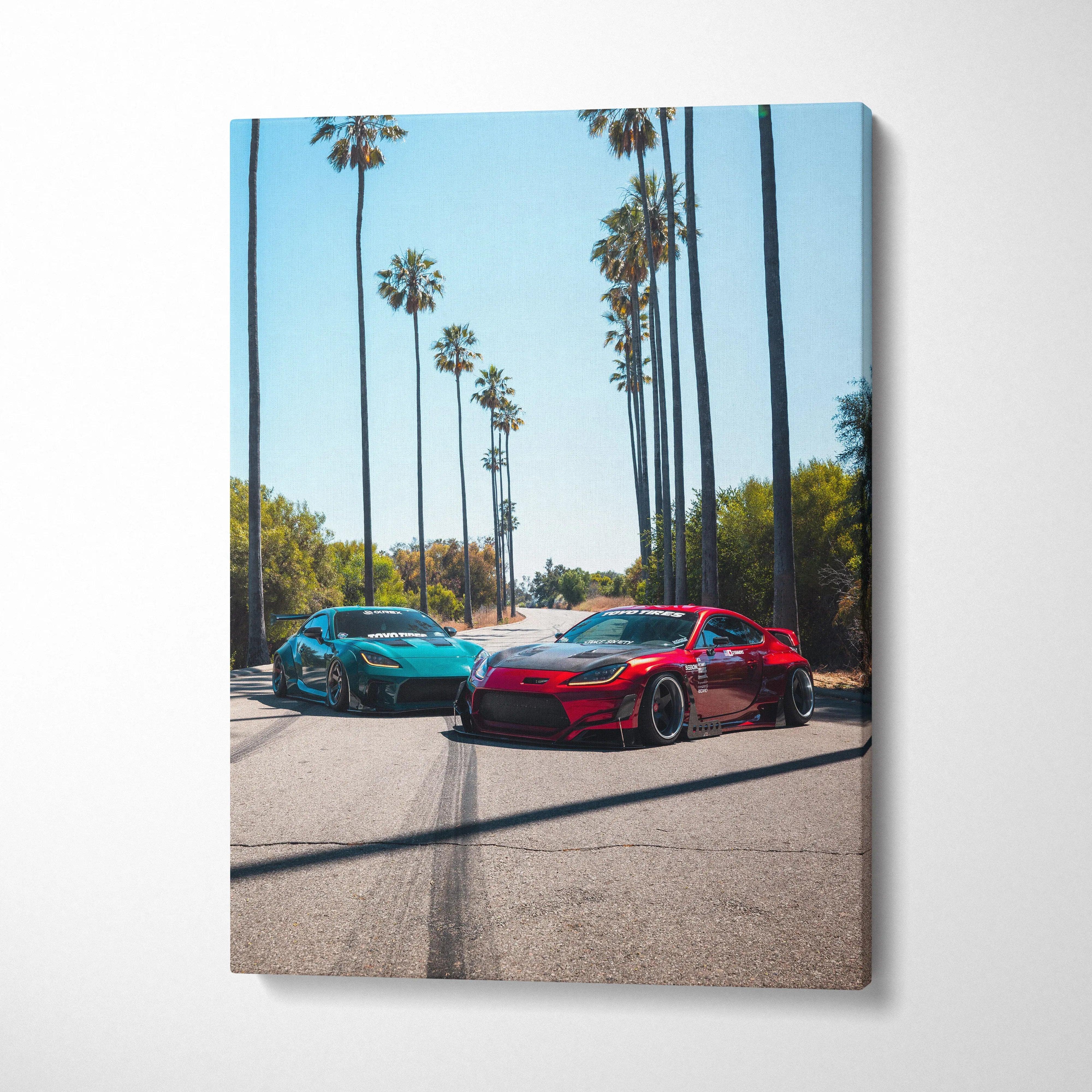 Vertical canvas art featuring red and blue Toyota GR86 cars on a sunny palm-lined street, wall art print.