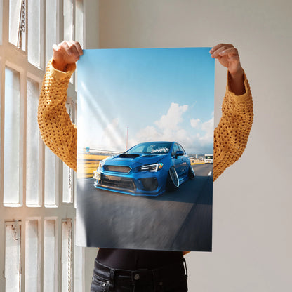 Slammed blue Subaru WRX parked on asphalt under clear sky poster wall art.