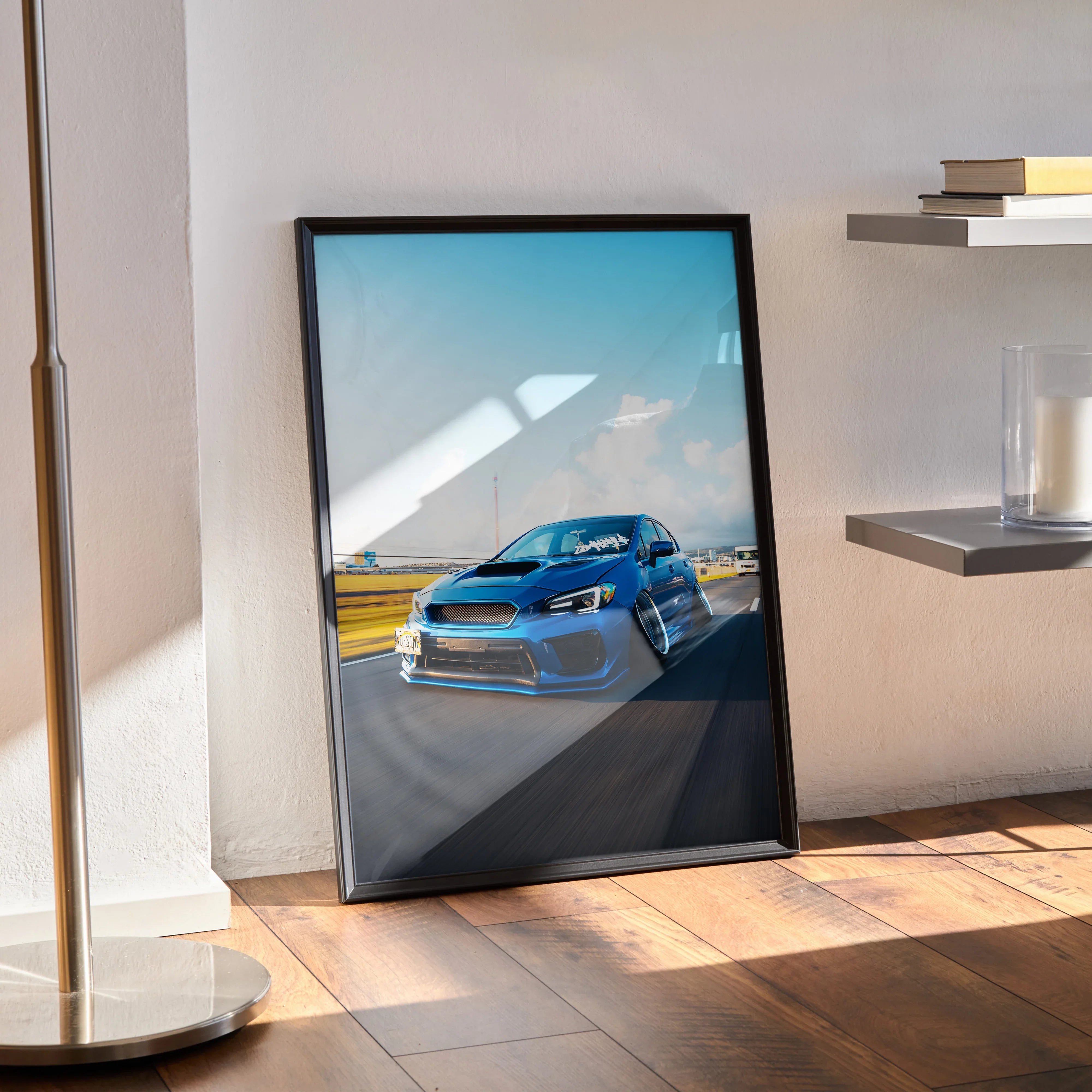 Framed poster of a slammed blue Subaru WRX on race track wall art with bright sky.
