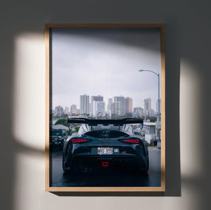 Toyota Supra Mk5 rear view Poster with city skyline, sleek black sports car Wall Art in wooden frame.