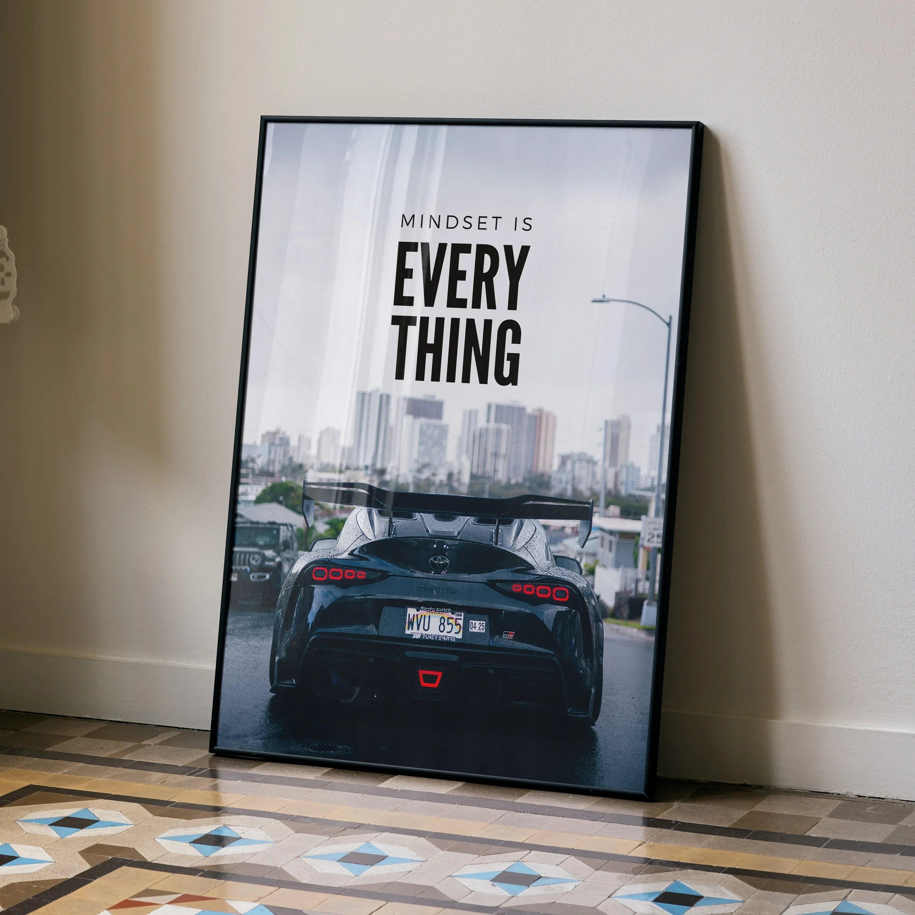 Motivational poster wall art featuring Toyota Supra Mk5 rear view with city skyline and inspiring text.