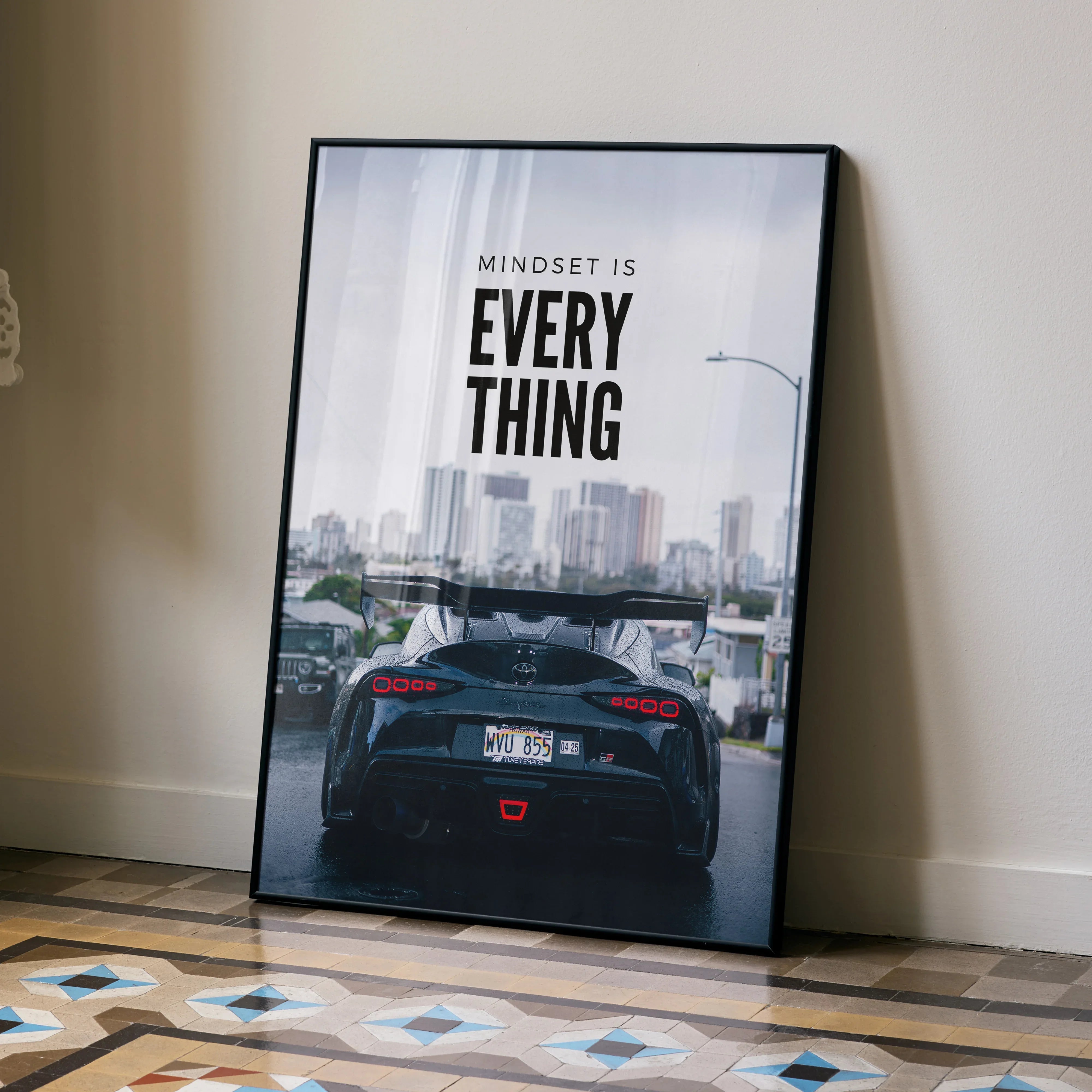 Motivational poster wall art featuring Toyota Supra Mk5 rear view with city skyline and inspiring text.