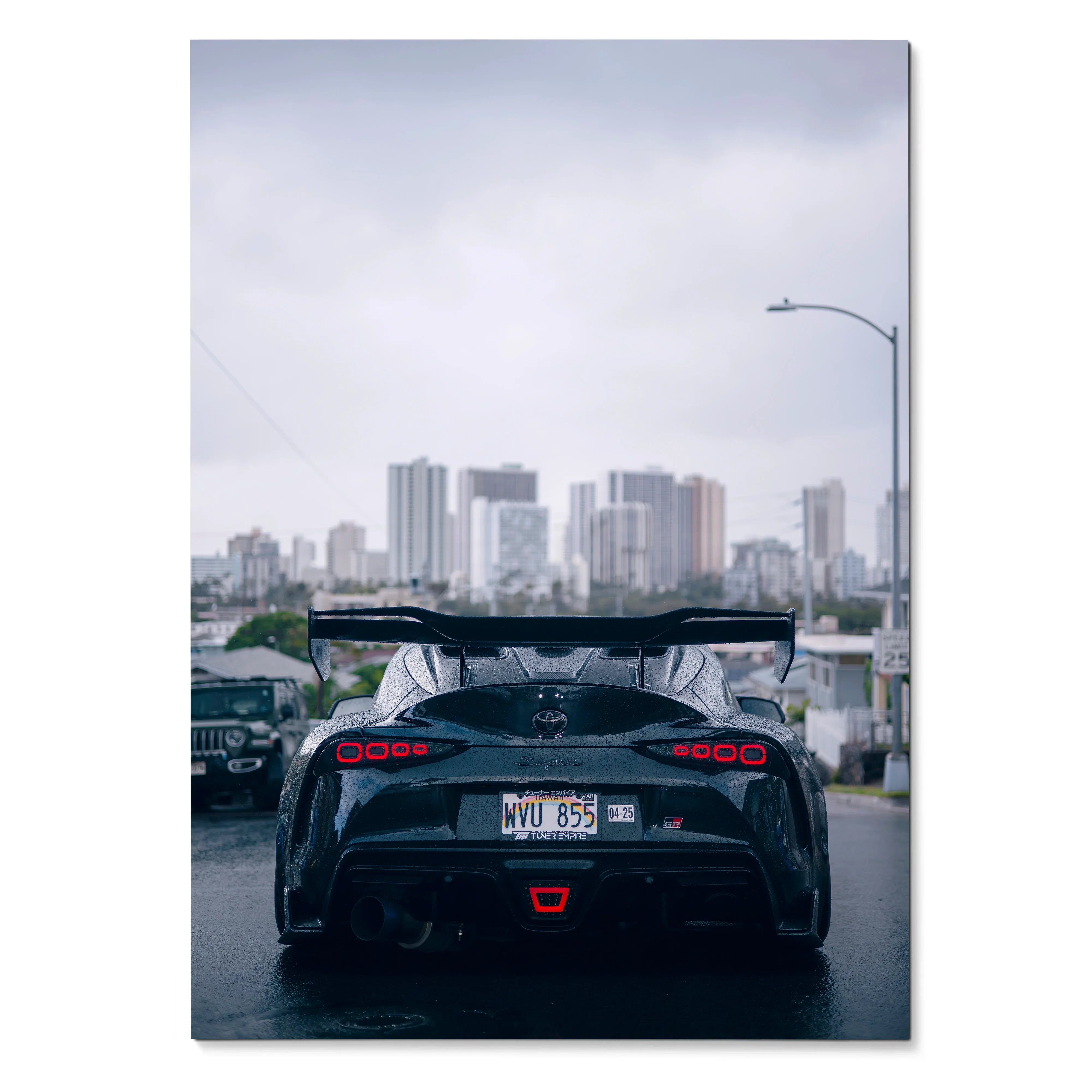 Toyota Supra Mk5 rear view poster showcasing sleek black car with city skyline background wall art.