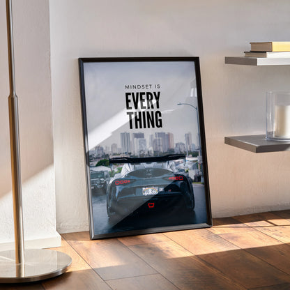 Toyota Supra Mk5 poster with motivational text and city skyline, modern wall art in black frame.