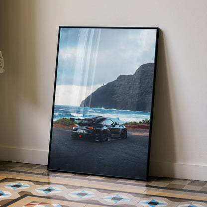 Toyota Supra Mk5 poster wall art featuring a black Supra on coastal road with mountains and ocean background.