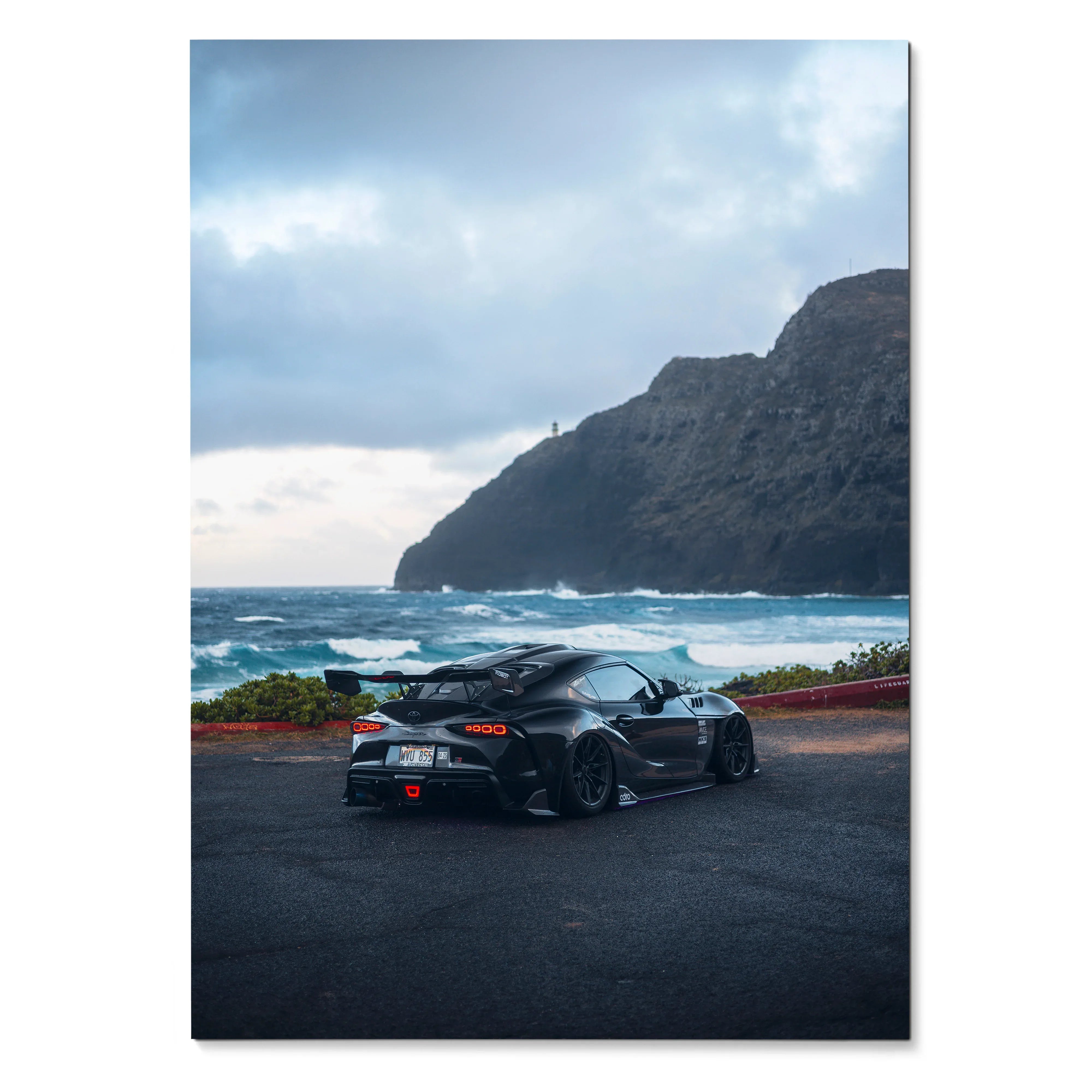 Toyota Supra Mk5 black sports car parked near ocean cliff at sunset wall art poster.