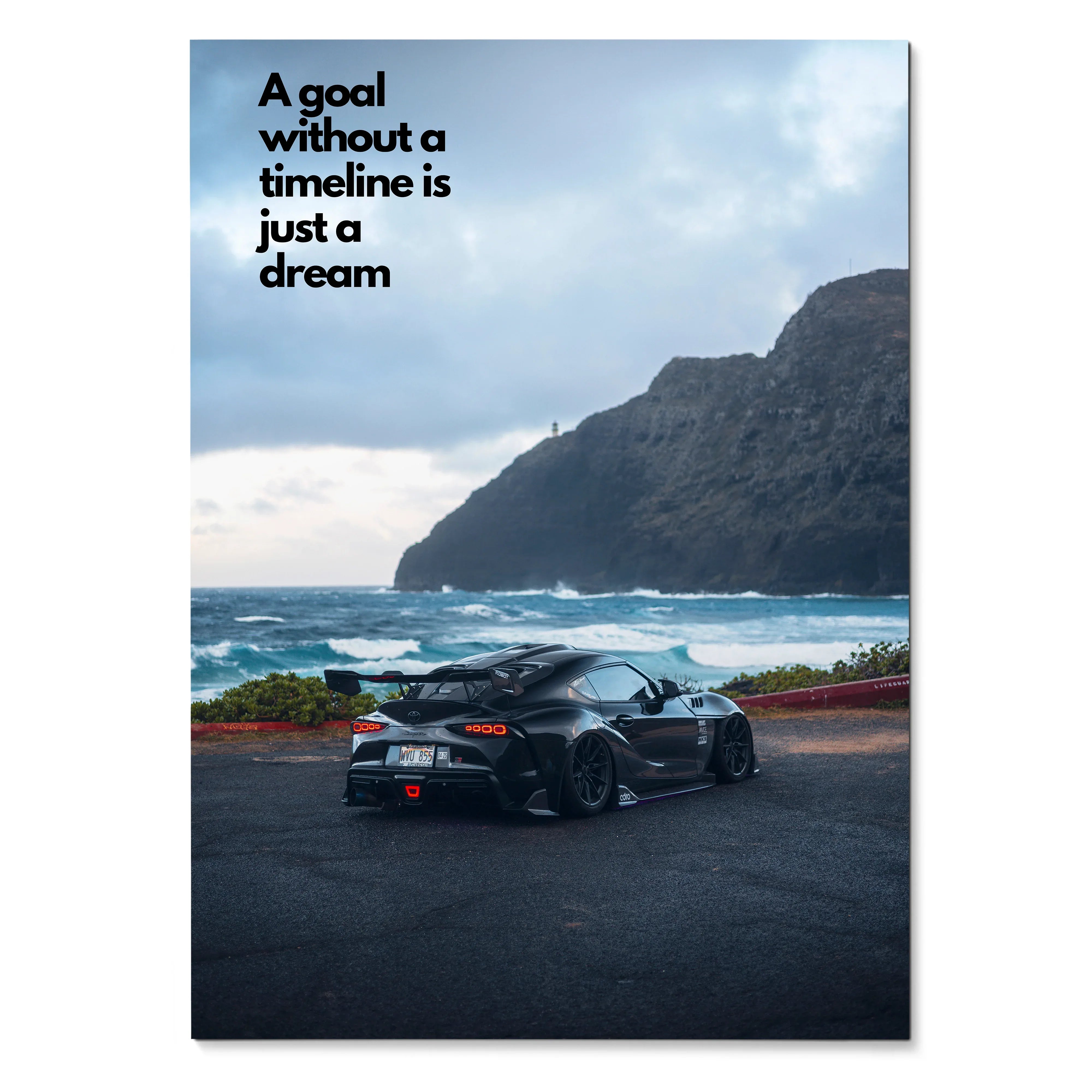 Motivational poster wall art featuring black Toyota Supra Mk5 by ocean with inspiring text on sky.