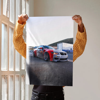BMW E92 M3 red and white car poster wall art held by person indoors.