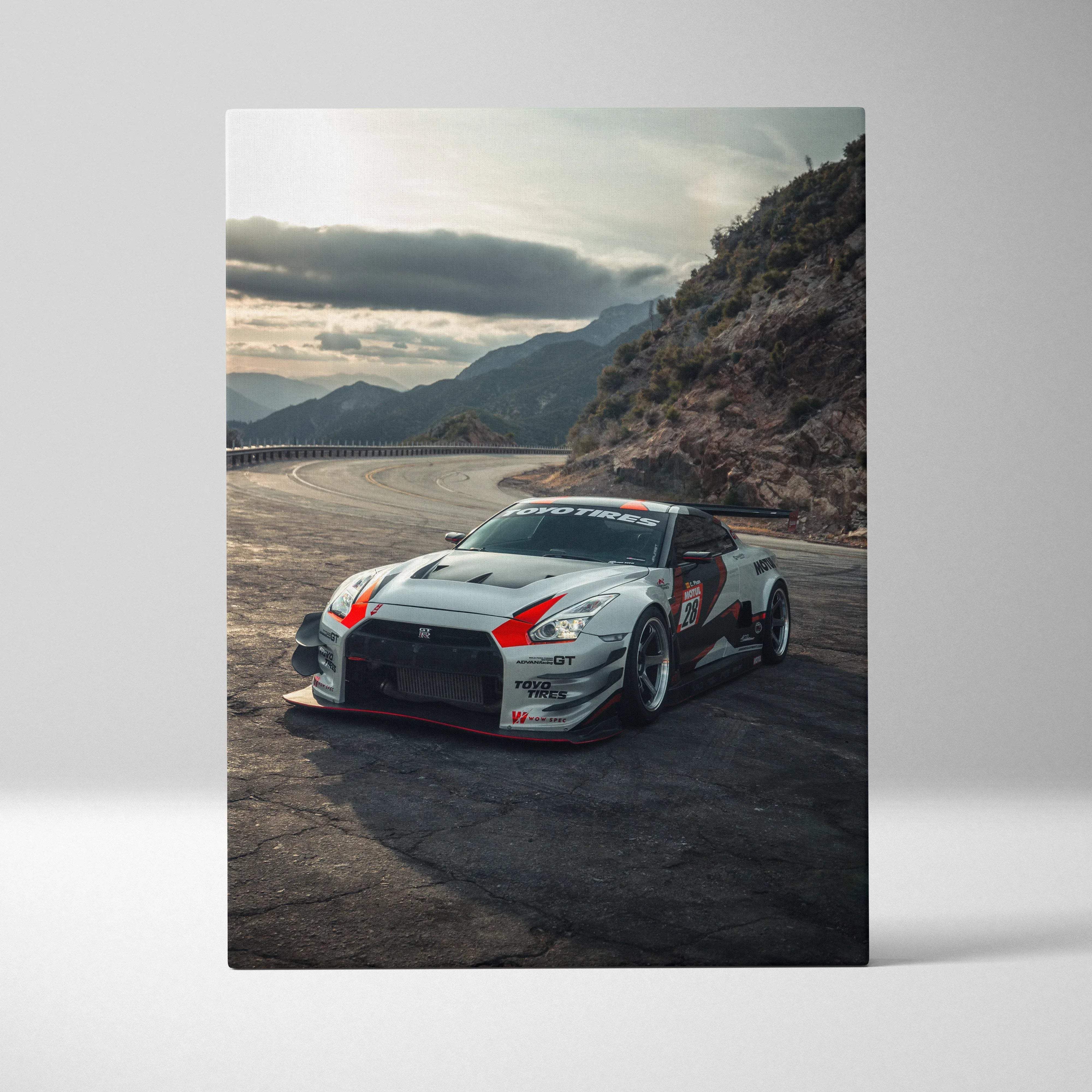 Canvas wall art featuring a white and red nissan r35 gtr race car with black accents on a bold mountain road scene