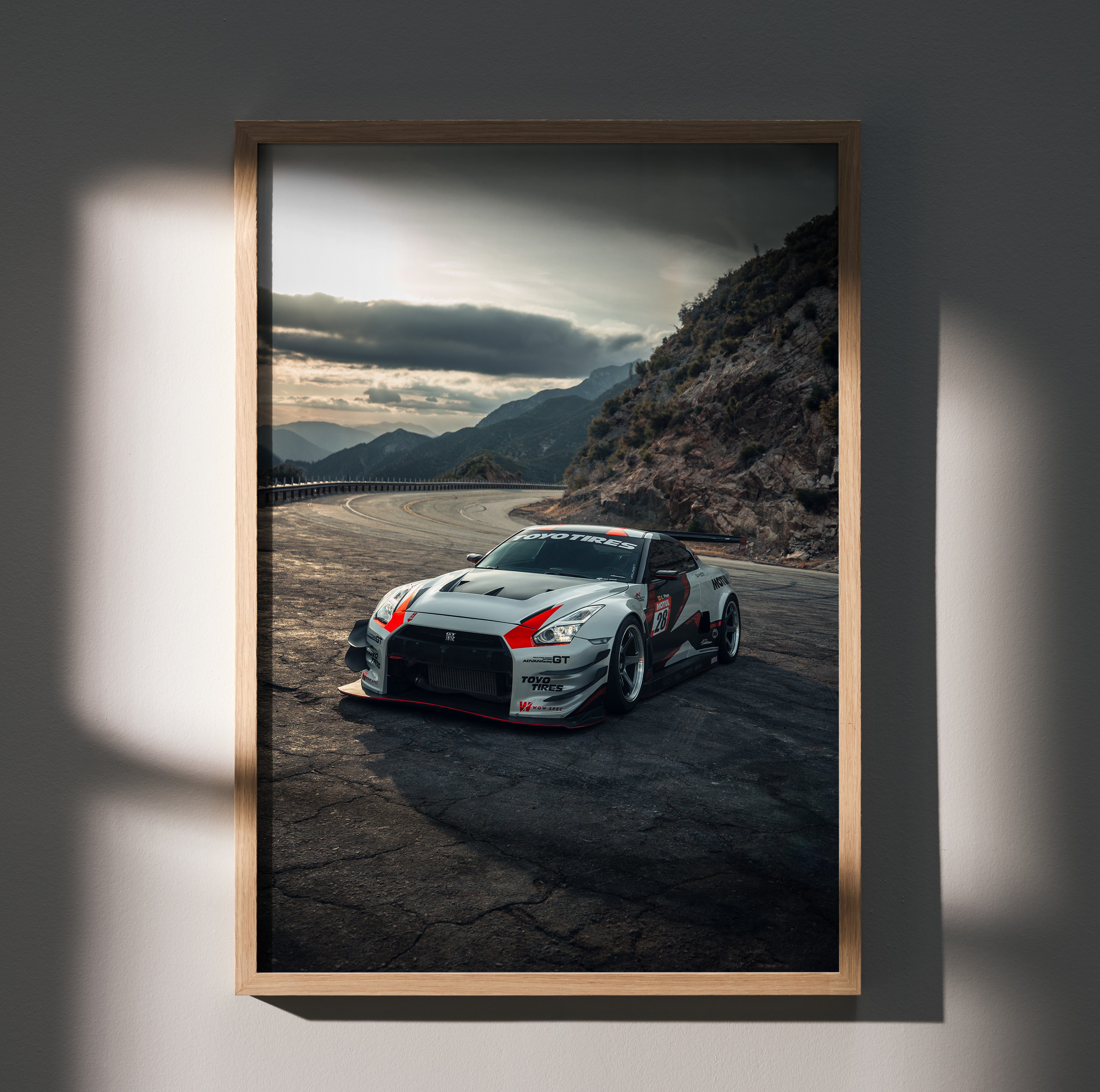 Nissan GTR R35 racing car on mountain road poster wall art in wooden frame.