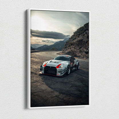 Nissan R35 GTR racing car on mountain road canvas wall art with dramatic sky backdrop.