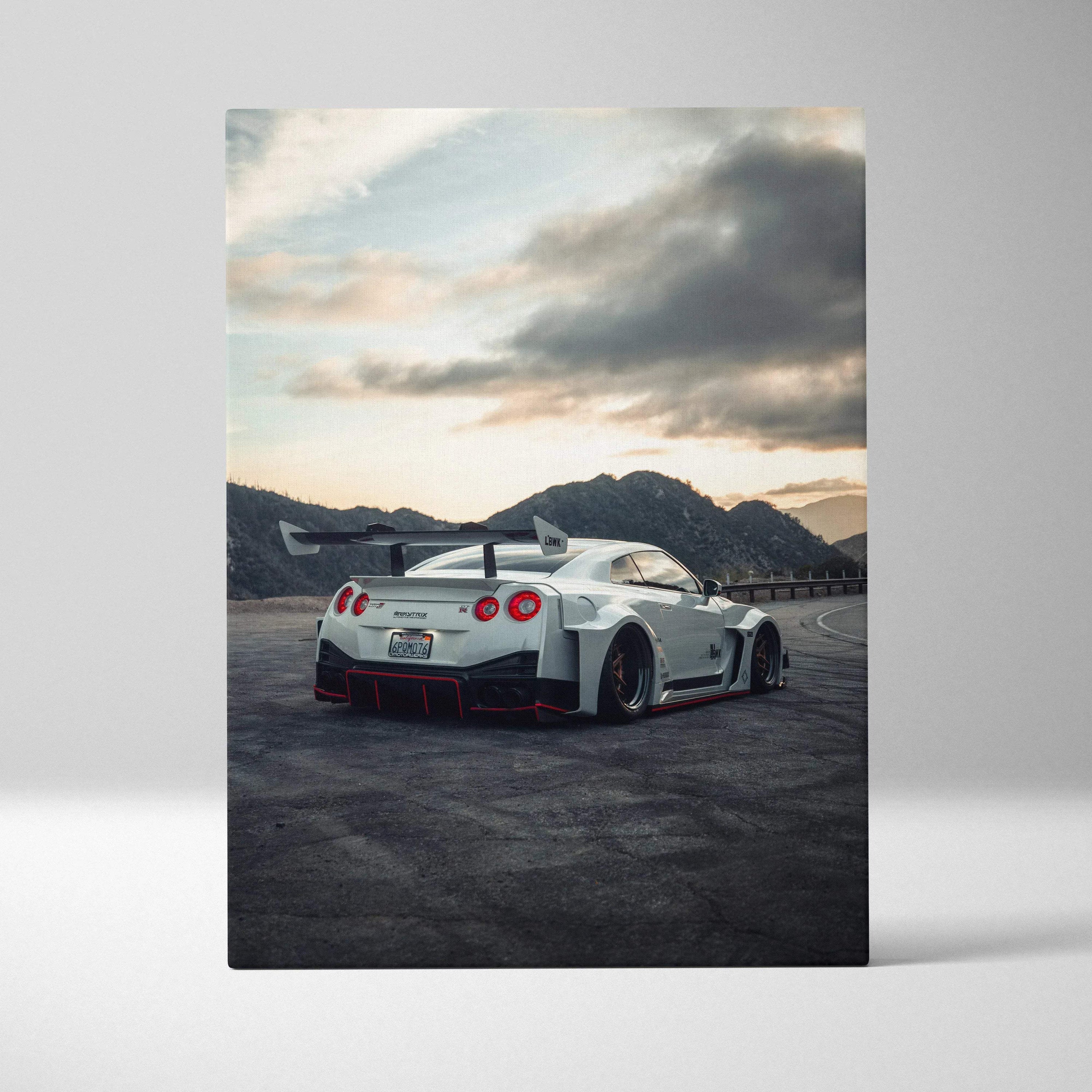 Nissan R35 GTR sports car in dark setting with mountain backdrop on vertical canvas wall art.