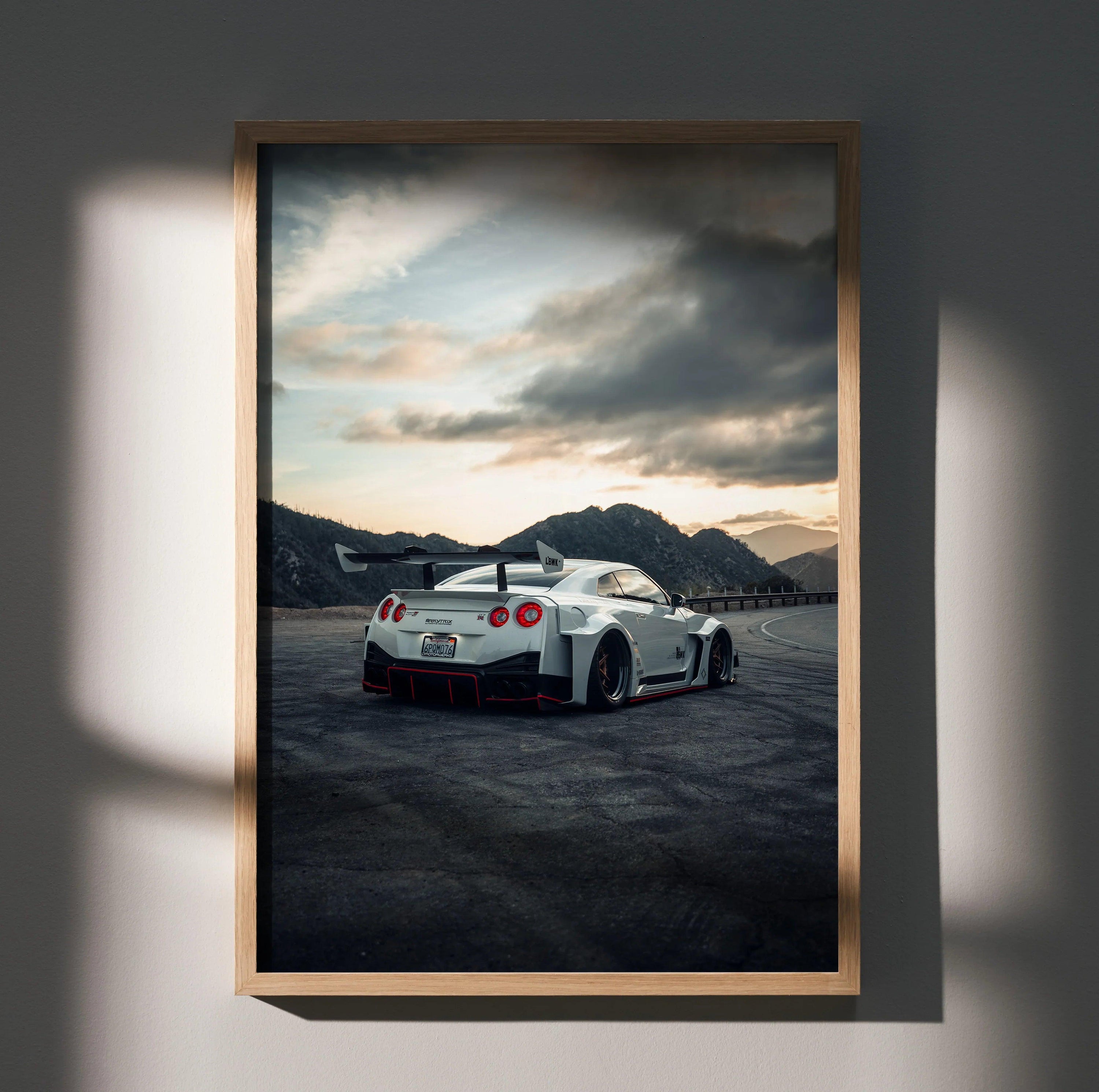Nissan GTR R35 white sports car poster wall art with mountain sunset background.